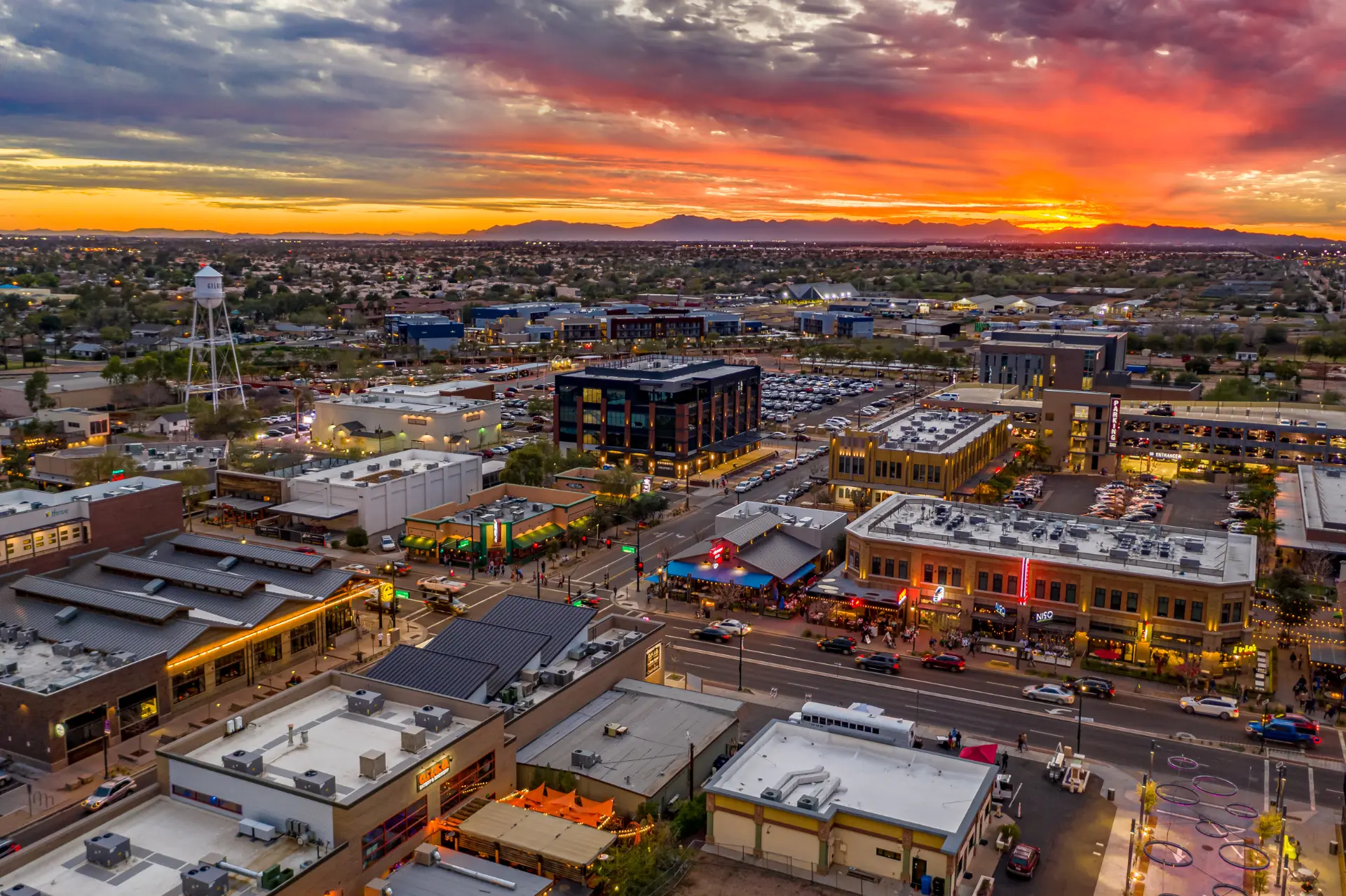 Aerial sunset view over downtown Gilbert with the iconic water tower and Heritage District lights